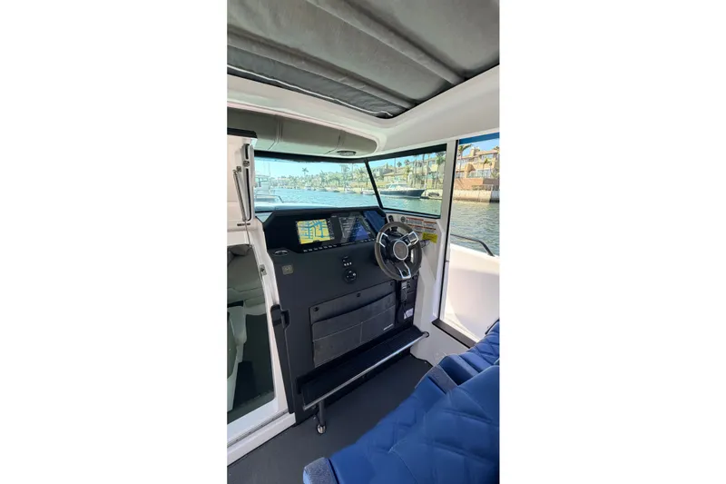 Slide: The Image of Interior view of 2024 Axopar 37 XC Cross Cabin, featuring modern helm and navigation displays. - 23