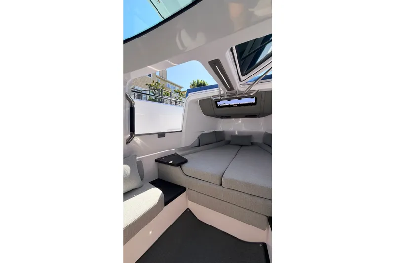 Slide: The Image of 2024 Axopar 37 XC Cross Cabin interior with modern seating and skylight. - 30