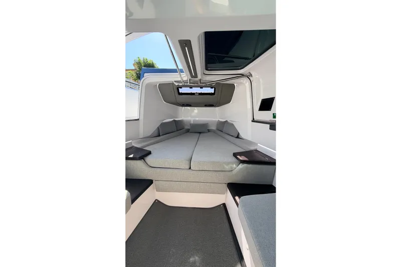 Slide: The Image of 2024 Axopar 37 XC Cross Cabin interior with modern gray seating and sleek design. - 29