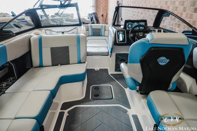 Slide: The Image of 2024 Malibu Wakesetter 23 LSV interior with blue and gray seating, modern dashboard. - 9