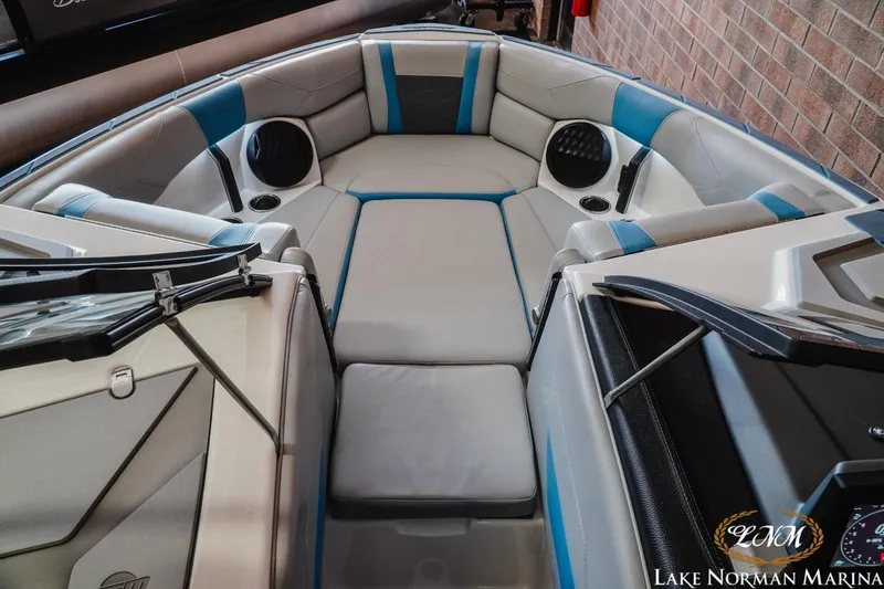 Slide: The Image of 2024 Malibu Wakesetter 23 LSV boat interior with blue and gray seating at Lake Norman Marina. - 12