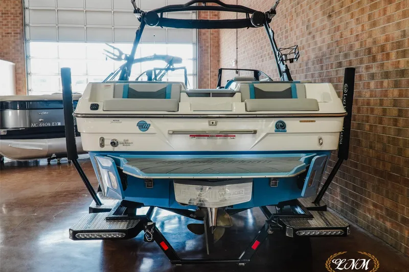Slide: The Image of 2024 Malibu Wakesetter 23 LSV boat in showroom, rear view with trailer. - 5