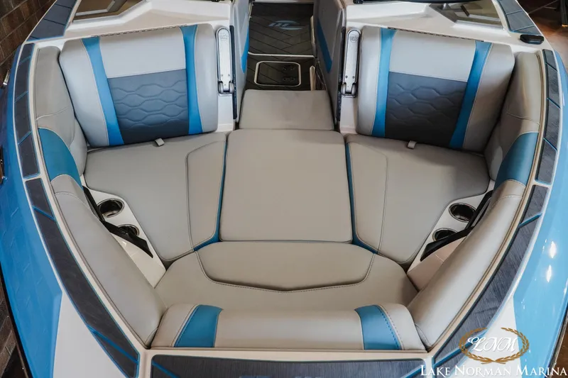 Slide: The Image of 2024 Malibu Wakesetter 23 LSV interior with blue and gray seating at Lake Norman Marina. - 13
