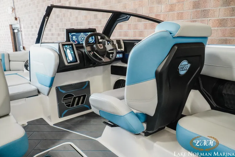 Slide: The Image of 2024 Malibu Wakesetter 23 LSV interior with modern dashboard and blue seating. - 10