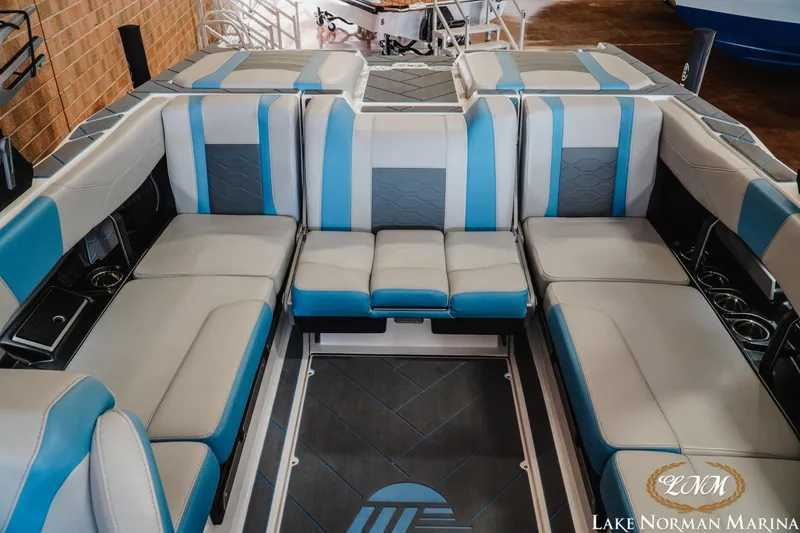 Slide: The Image of 2024 Malibu Wakesetter 23 LSV interior with blue and gray seating at Lake Norman Marina. - 15