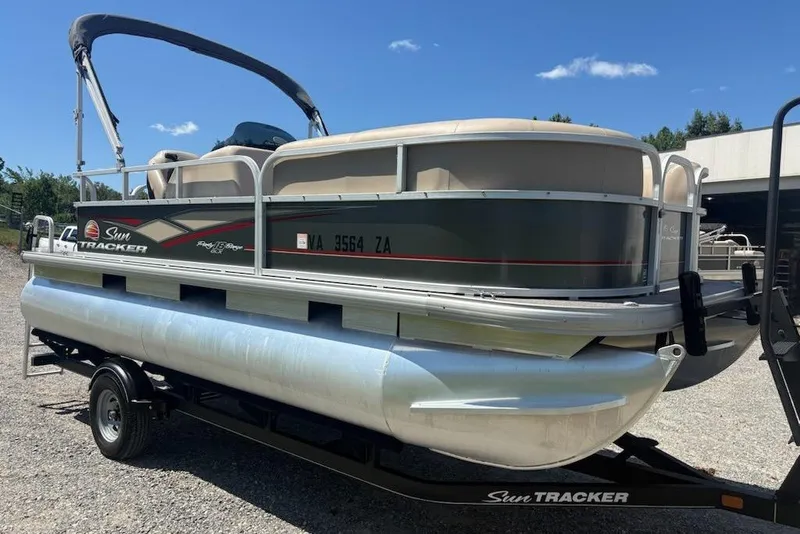 The Image of 2019 Sun Tracker Party Barge 18 DLX pontoon boat on trailer, parked outdoors. - 0