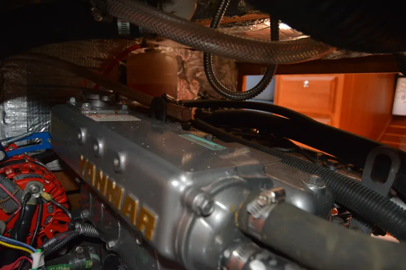 Slide: The Image of Engine compartment of a 2002 Sabre 402 sailboat with Yanmar engine components. - 136