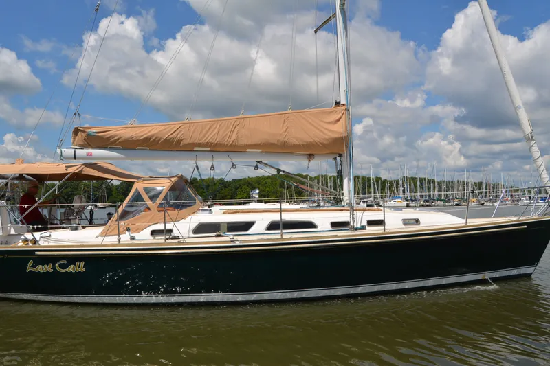 Slide: The Image of 2002 Sabre 402 sailboat "Last Call" docked on a sunny day with cloudy sky. - 5