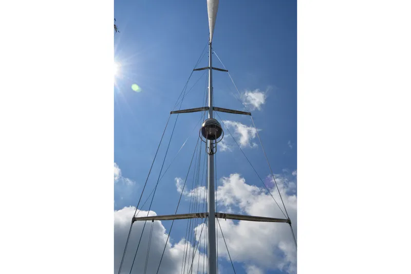 Slide: The Image of Tall sailboat mast of 2002 Sabre 402 against a bright blue sky. - 33