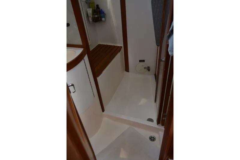 Slide: The Image of Compact bathroom interior of 2002 Sabre 402 yacht with wooden accents and shower area. - 116