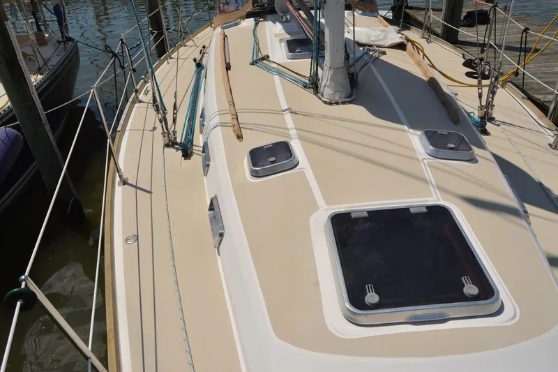 Slide: The Image of 2002 Sabre 402 sailboat deck with hatches and rigging at a marina. - 37