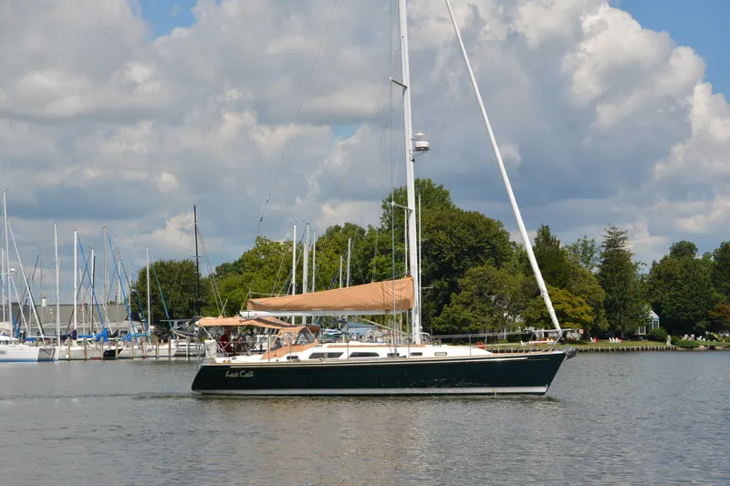 Slide: The Image of Sailing yacht Sabre 402 from 2002 on a calm lake with cloudy sky. - 11