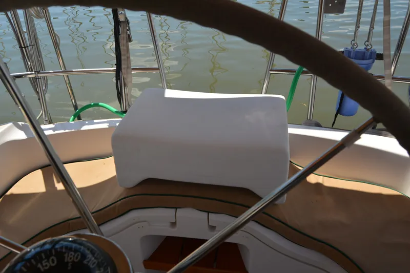 Slide: The Image of Cockpit view of a 2002 Sabre 402 sailboat with steering wheel and compass. - 56