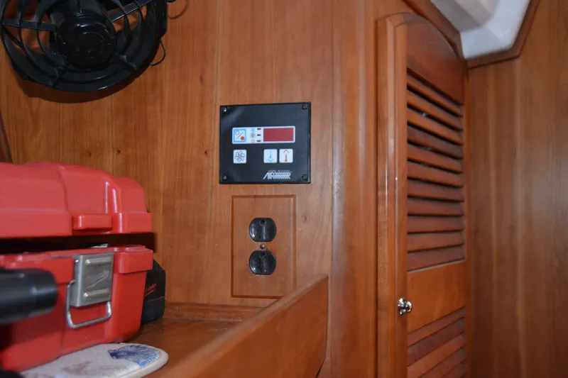 Slide: The Image of Interior of a 2002 Sabre 402 yacht with control panel and red toolbox. - 132