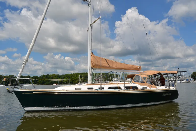 Slide: The Image of 2002 Sabre 402 sailboat on calm water under a partly cloudy sky. - 16