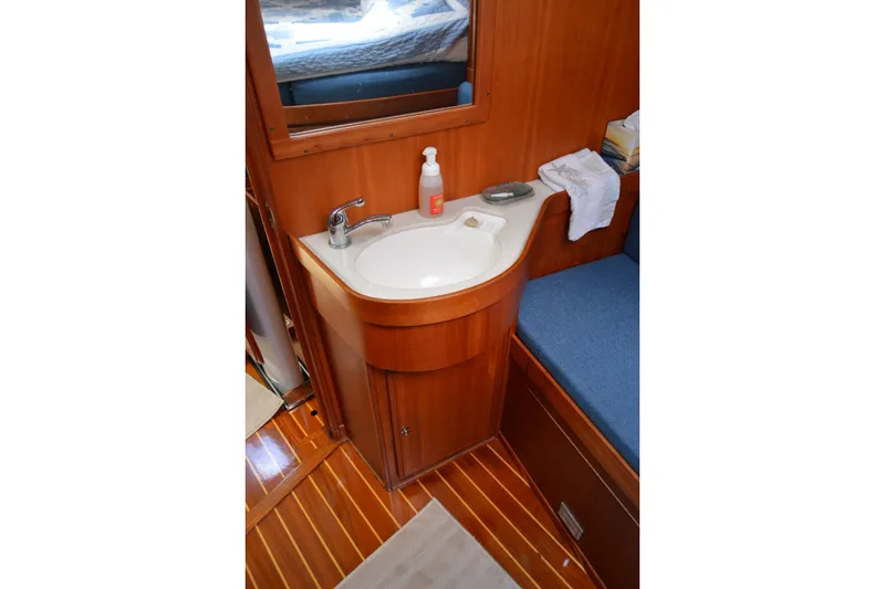 Slide: The Image of Wooden bathroom vanity with sink in 2002 Sabre 402 yacht interior. - 94