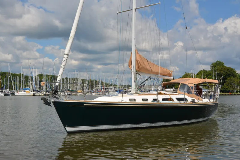 Slide: The Image of Sailing yacht Sabre 402, 2002 model, anchored in a marina under a partly cloudy sky. - 14