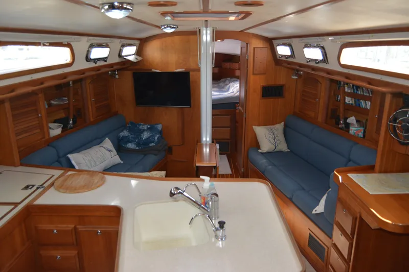 Slide: The Image of Interior of a 2002 Sabre 402 yacht with cozy seating and wooden cabinetry. - 69