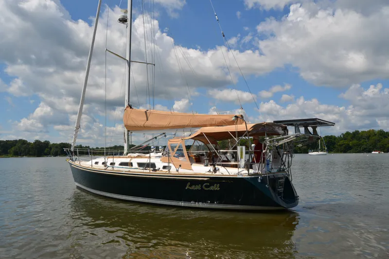 Slide: The Image of Sailing yacht Sabre 402, 2002 model, anchored on a calm lake under a cloudy sky. - 17