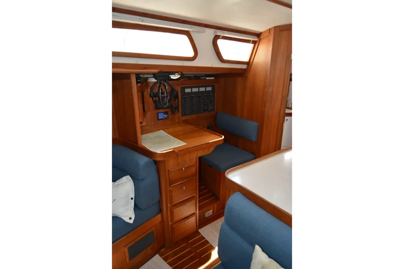 Slide: The Image of Interior of 2002 Sabre 402 sailboat with wooden cabinetry and blue seating. - 107