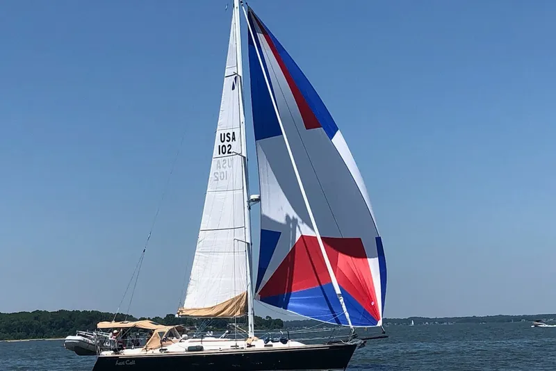 Slide: The Image of Sailing yacht Sabre 402 (2002) with colorful spinnaker on open water. - 20