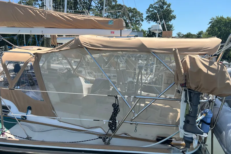 Slide: The Image of 2002 Sabre 402 sailboat with tan canvas cover docked at marina. - 52
