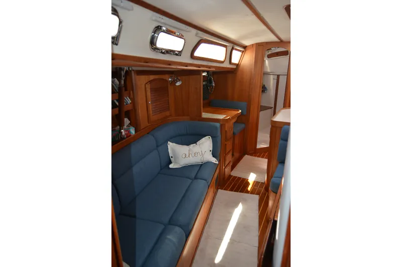 Slide: The Image of Interior of 2002 Sabre 402 sailboat with blue seating and wooden finishes. - 95