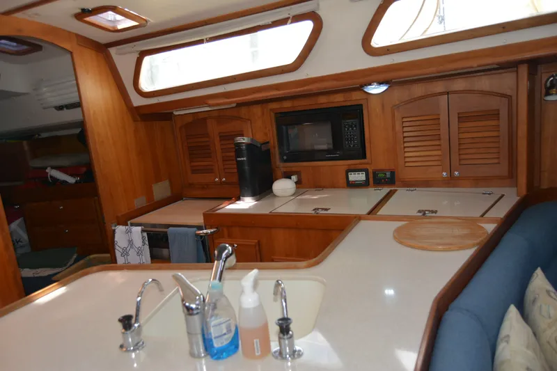 Slide: The Image of Interior of 2002 Sabre 402 yacht kitchen with wooden cabinetry and modern appliances. - 104
