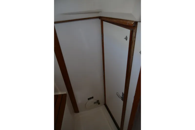 Slide: The Image of Interior view of a 2002 Sabre 402 sailboat bathroom with wooden trim. - 122