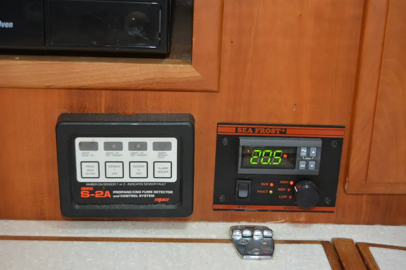 Slide: The Image of Control panels on a 2002 Sabre 402 yacht, featuring Sea Frost and Xintex systems. - 81