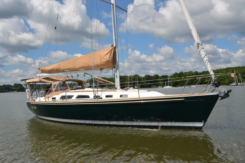 Slide: The Image of 2002 Sabre 402 sailboat on calm water under a partly cloudy sky. - 3
