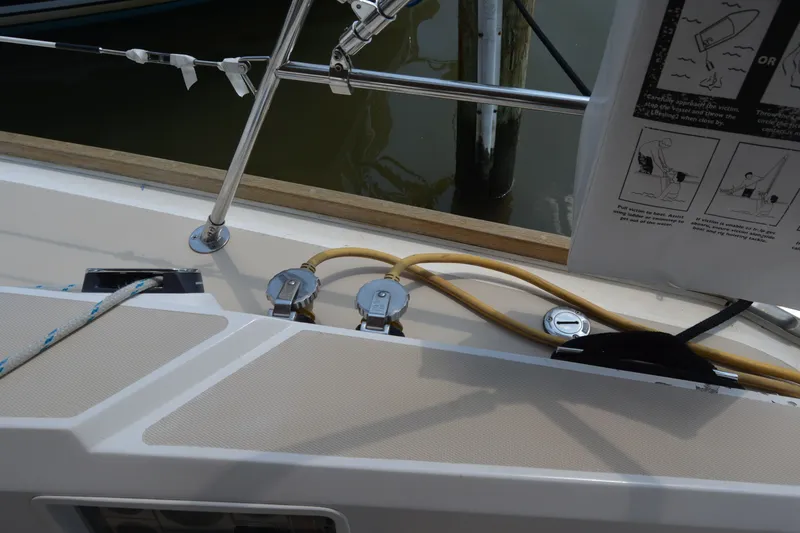 Slide: The Image of Deck of 2002 Sabre 402 sailboat with ropes and safety instructions. - 65