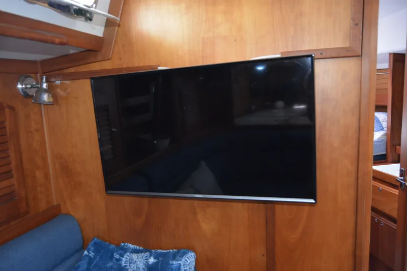 Slide: The Image of Flat-screen TV mounted on wooden wall inside 2002 Sabre 402 yacht interior. - 101