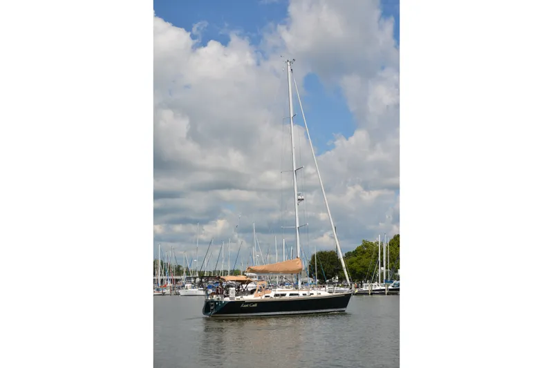 Slide: The Image of Sailing yacht Sabre 402, 2002 model, docked under a partly cloudy sky. - 10