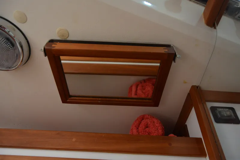 Slide: The Image of Wooden framed mirror and red towels in Sabre 402 yacht interior, 2002 model. - 120