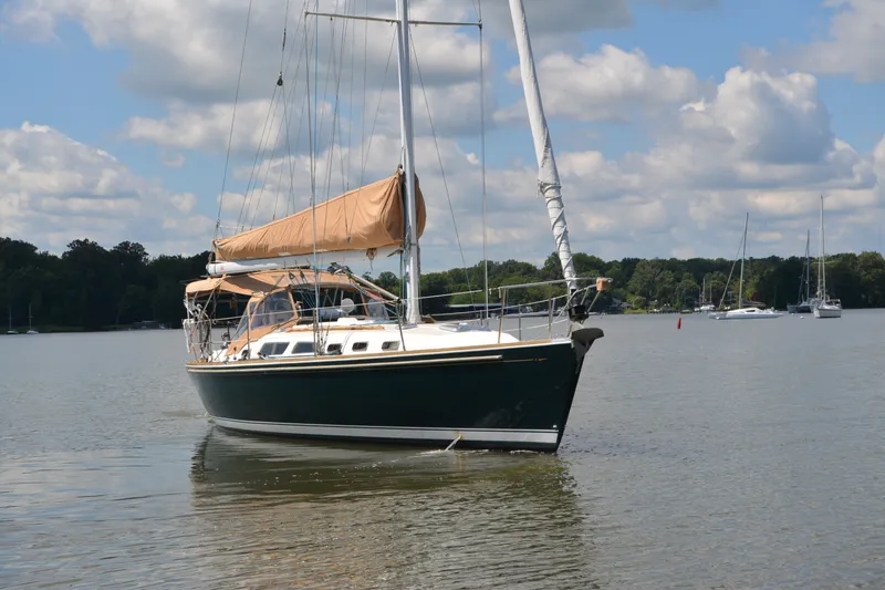 Slide: The Image of Sailing yacht Sabre 402 from 2002 on calm waters under a blue sky. - 2