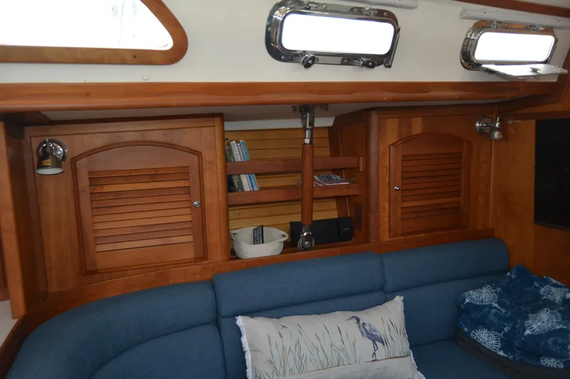Slide: The Image of Interior of 2002 Sabre 402 sailboat with wooden cabinets and blue seating. - 99