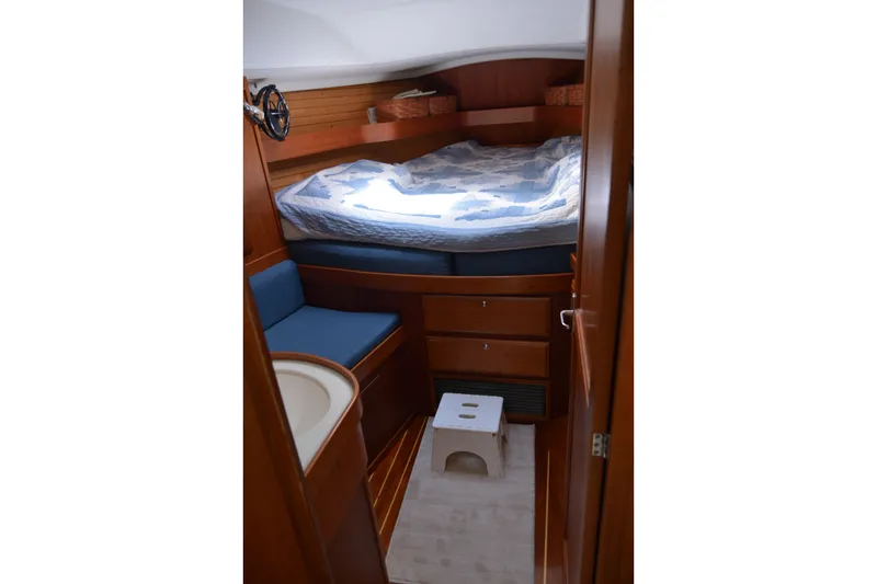 Slide: The Image of Cozy cabin interior of a 2002 Sabre 402 sailboat with wooden furnishings and a comfortable bed. - 88
