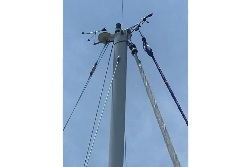 Slide: The Image of Mast of 2002 Sabre 402 sailboat with rigging and instruments against blue sky. - 26