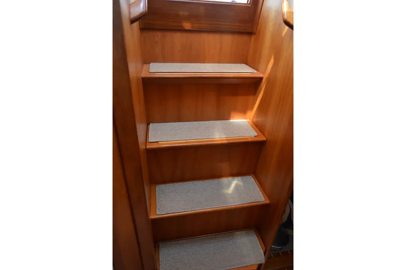 Slide: The Image of Wooden stairs with carpeted steps inside a 2002 Sabre 402 yacht. - 123