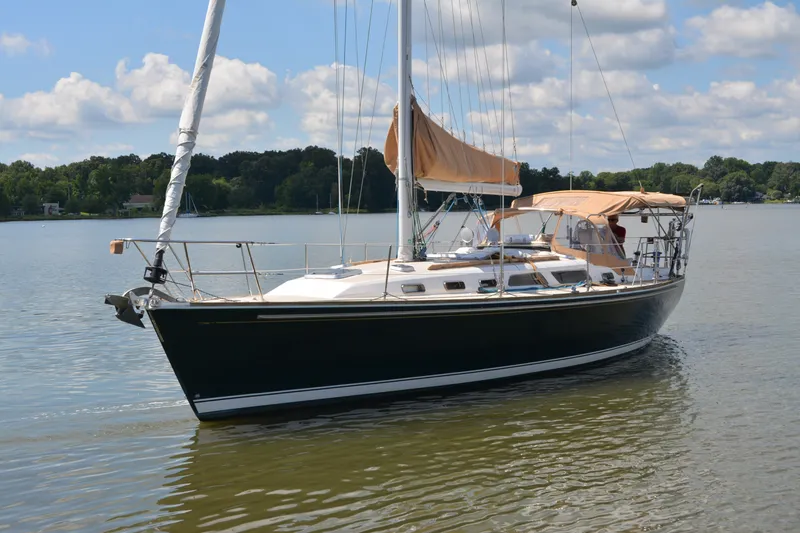 Slide: The Image of Sailing yacht Sabre 402, 2002 model, on calm water under a partly cloudy sky. - 1