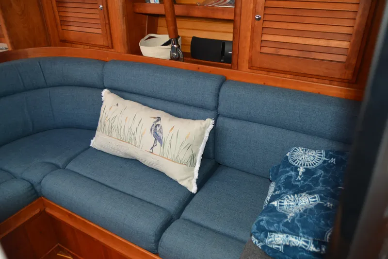Slide: The Image of Cozy interior of 2002 Sabre 402 yacht with blue seating and decorative pillows. - 97