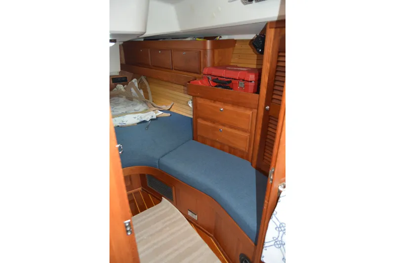 Slide: The Image of Cozy cabin interior of 2002 Sabre 402 sailboat with wooden cabinetry and blue cushions. - 126