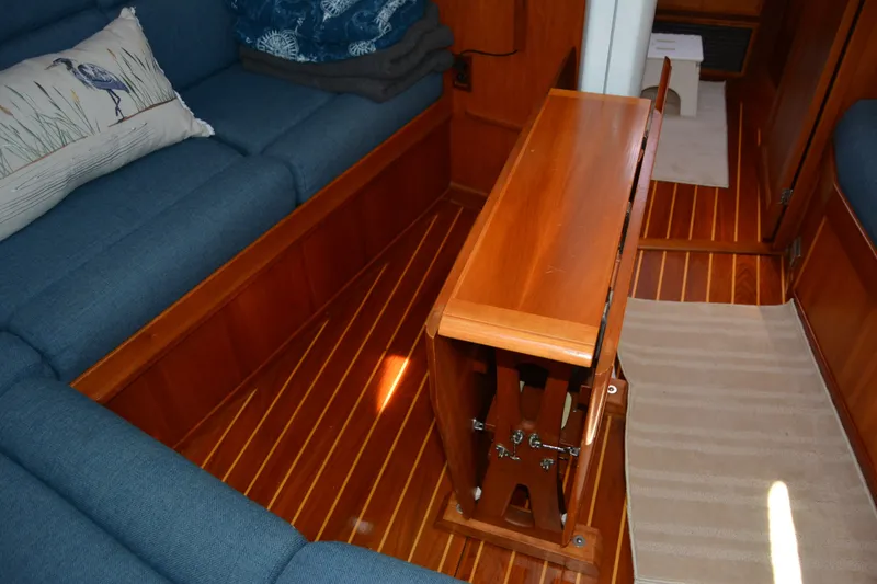Slide: The Image of Interior of 2002 Sabre 402 yacht with wooden flooring and blue seating. - 100