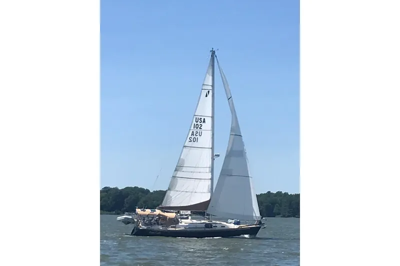 Slide: The Image of Sailing yacht Sabre 402 from 2002 on a sunny day, with full sails. - 19
