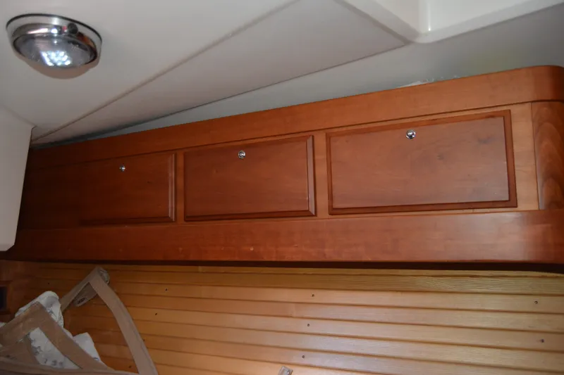 Slide: The Image of Wooden cabinets inside a 2002 Sabre 402 boat, featuring sleek design and ample storage. - 134
