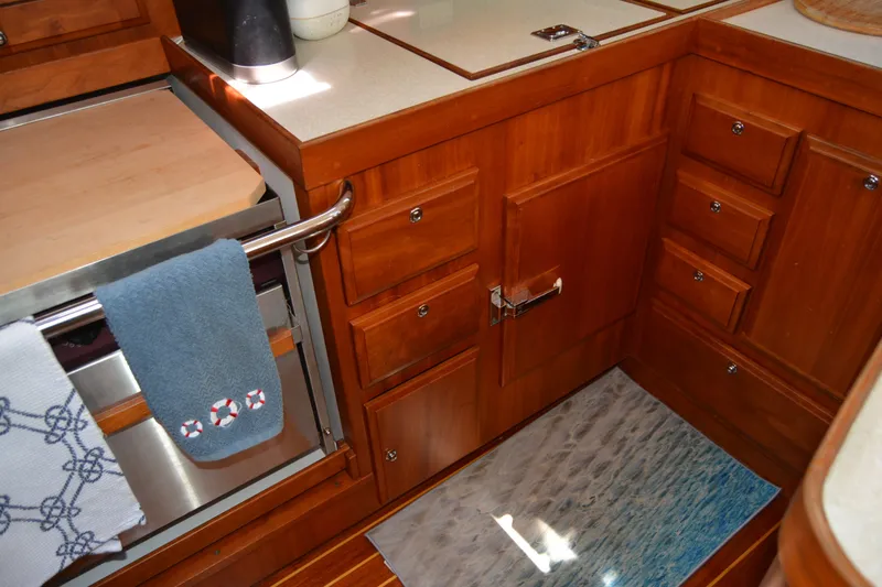 Slide: The Image of Wooden kitchen interior of 2002 Sabre 402 yacht with towels and cabinetry. - 83