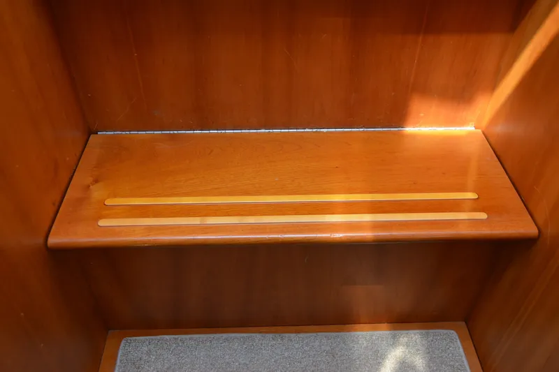 Slide: The Image of Wooden interior step in a 2002 Sabre 402 yacht, featuring a carpeted lower step. - 124