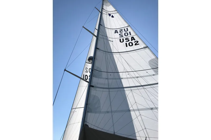 Slide: The Image of Sail of a 2002 Sabre 402 yacht against a clear blue sky. - 23