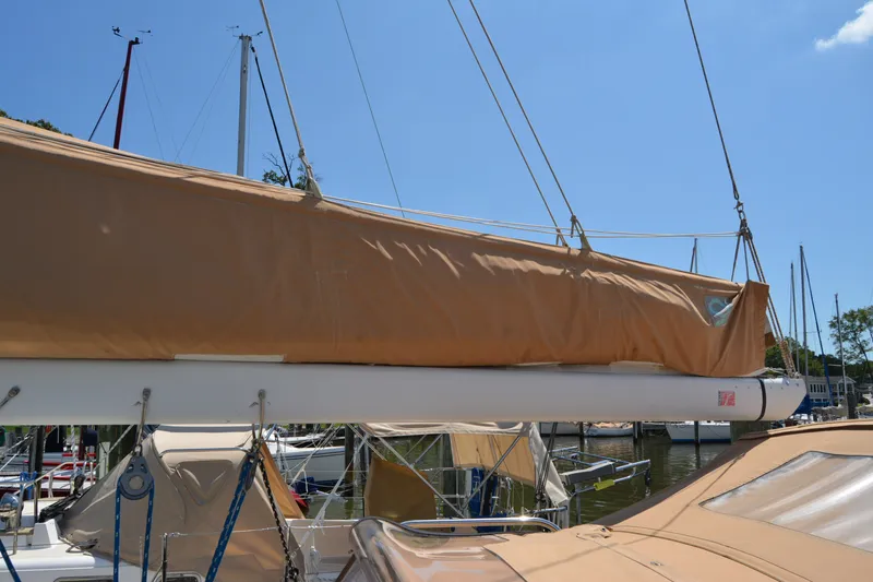 Slide: The Image of Sailboat Sabre 402, 2002 model, docked with tan sail cover under clear blue sky. - 49